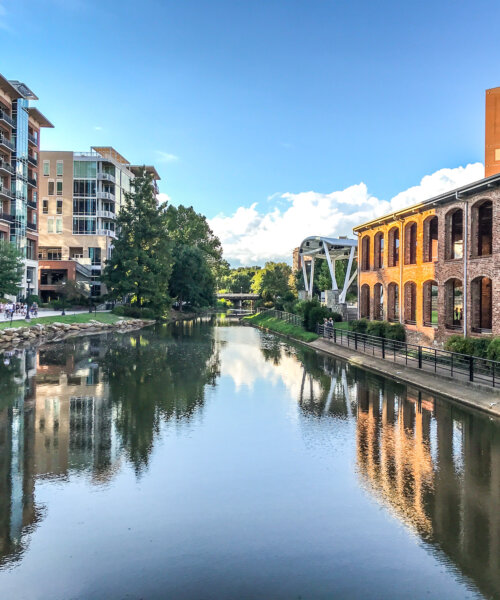 The Reedy River gently flows through the city district of Greenville, South Carolina. This river and walkway offers a peaceful setting to locals and visitors alike. As the sun sets on the city the reflection brought the with it a peaceful setting.